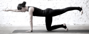 Woman posing on yoga mat